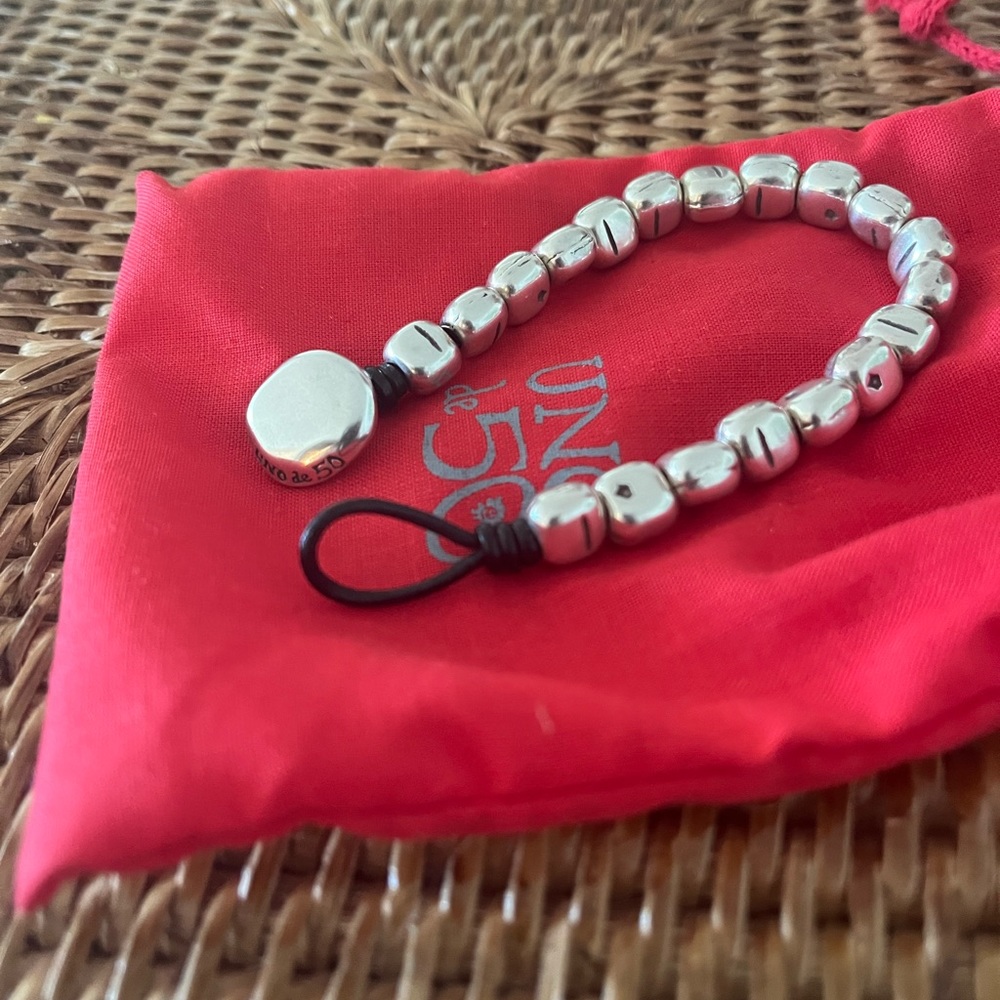Uno de 50 bracelet. Metal beats on leather.